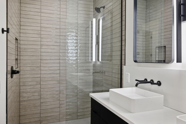 bathroom with vanity and tiled shower