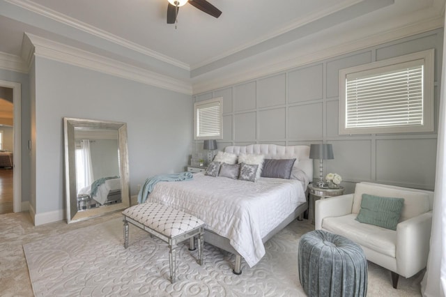 bedroom with ceiling fan, light colored carpet, ornamental molding, and multiple windows