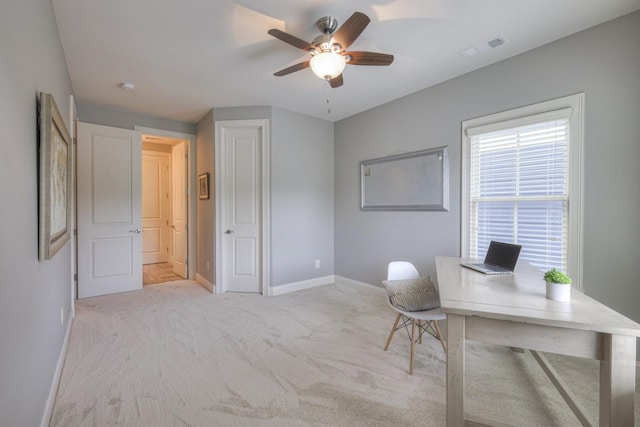 carpeted home office with ceiling fan