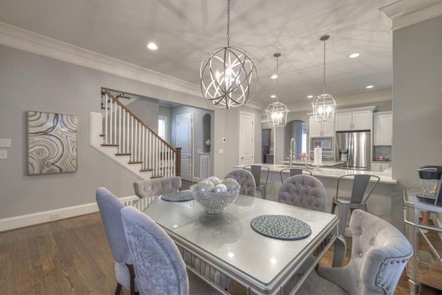 dining space featuring dark hardwood / wood-style floors, crown molding, and sink