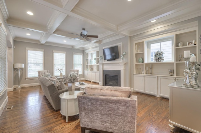 living room with beam ceiling, built in shelves, coffered ceiling, dark hardwood / wood-style floors, and crown molding