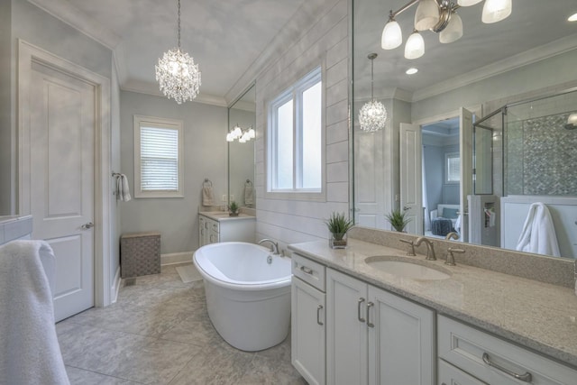 bathroom with crown molding, plenty of natural light, vanity, and a chandelier