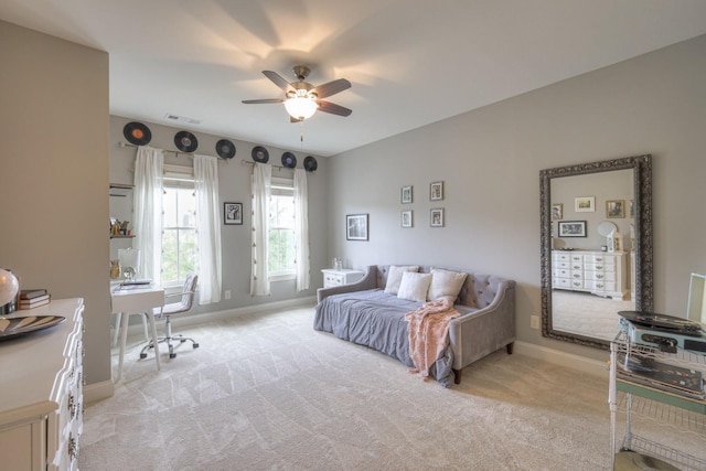 bedroom with ceiling fan and light colored carpet