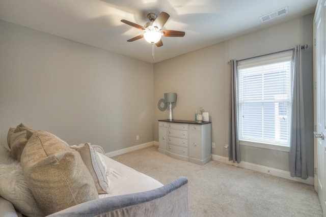 sitting room with ceiling fan and light carpet