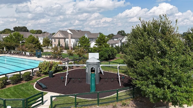 exterior space with a yard and a community pool