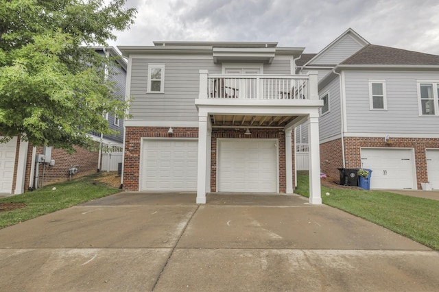 view of front of property with a front yard, a balcony, and a garage