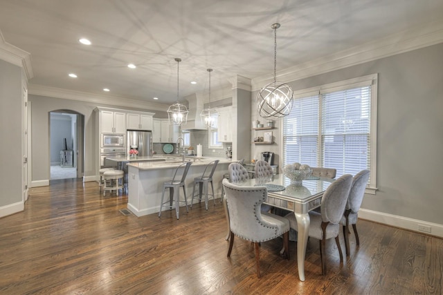 dining space with ornamental molding and dark wood-type flooring