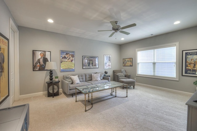 carpeted living room with ceiling fan