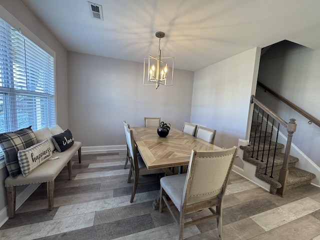 dining room with an inviting chandelier and light hardwood / wood-style floors