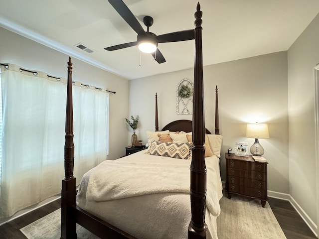 bedroom with dark hardwood / wood-style flooring and ceiling fan