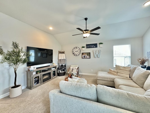 living room featuring ceiling fan, lofted ceiling, and light carpet