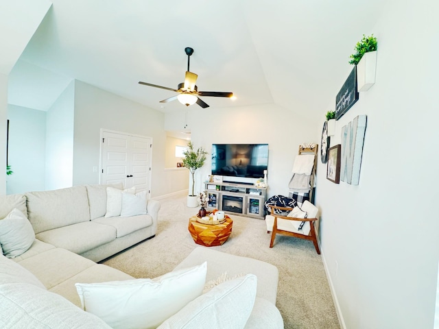 living room with ceiling fan, carpet, and lofted ceiling