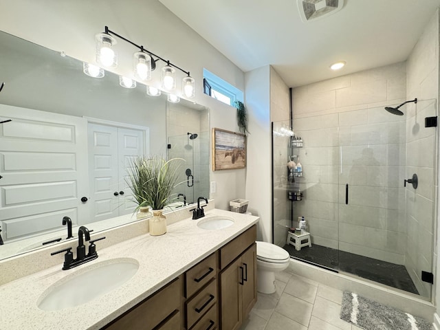 bathroom featuring tile patterned floors, a shower with door, vanity, and toilet