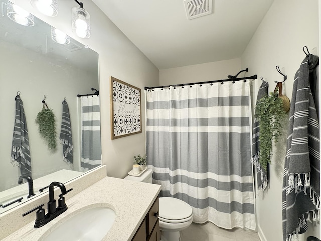 bathroom featuring tile patterned floors, vanity, and toilet