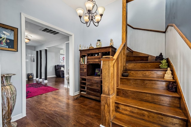 staircase featuring a notable chandelier and hardwood / wood-style flooring