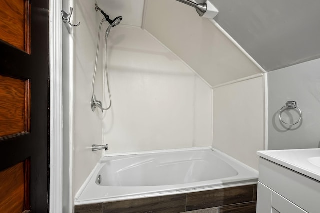 bathroom featuring vanity and tiled shower / bath