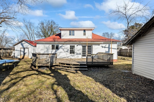 back of house with a yard and a deck