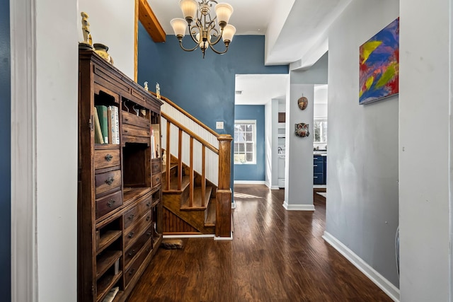 interior space with beam ceiling, wood-type flooring, and an inviting chandelier