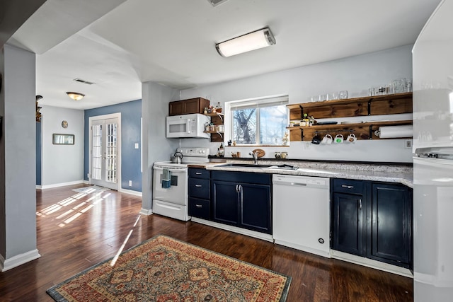 kitchen with french doors, sink, dark hardwood / wood-style floors, blue cabinets, and white appliances