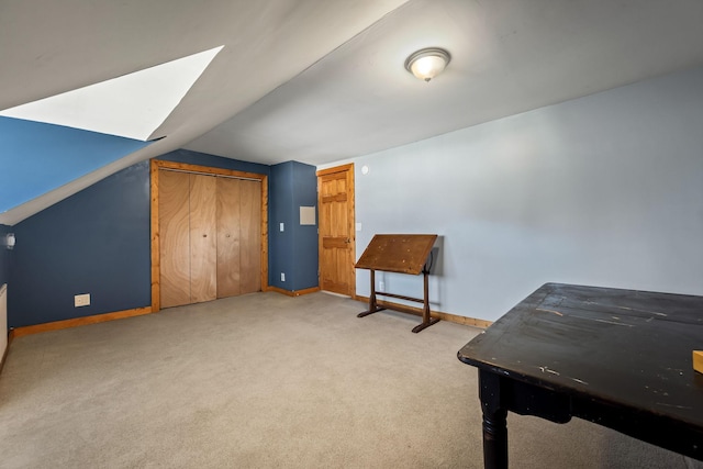 interior space featuring light colored carpet and lofted ceiling