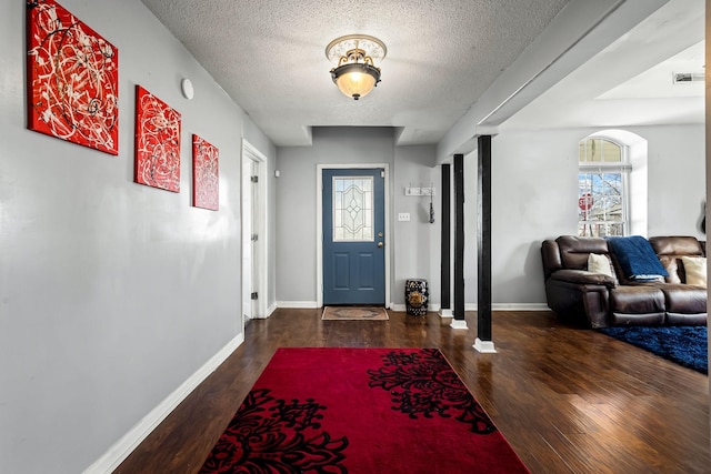 entrance foyer featuring dark hardwood / wood-style floors and a textured ceiling