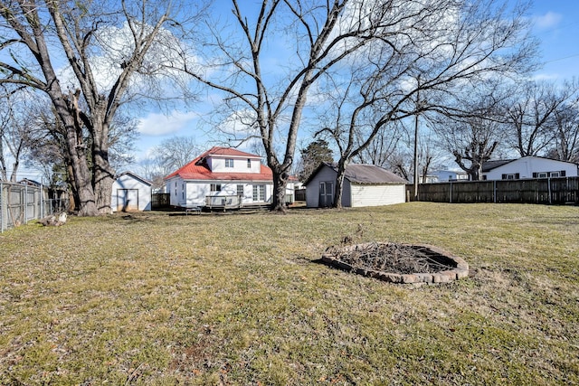 view of yard featuring a fire pit and an outdoor structure