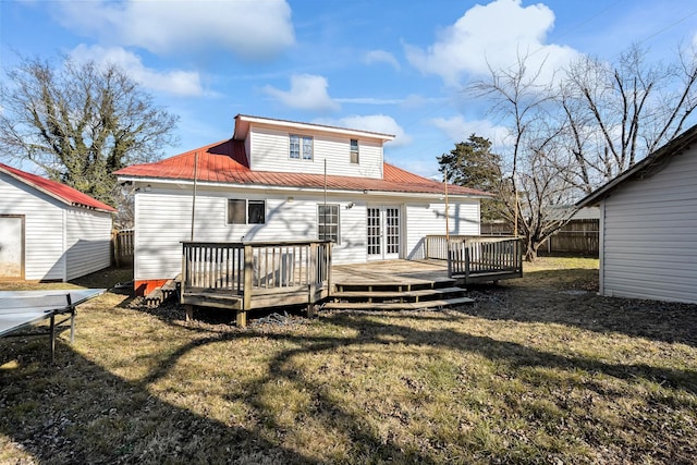 rear view of house featuring a storage unit, a yard, and a wooden deck