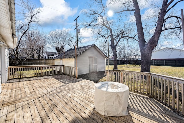 wooden terrace with a yard and an outdoor structure