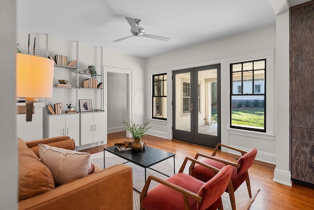 living room with ceiling fan, wood-type flooring, and french doors