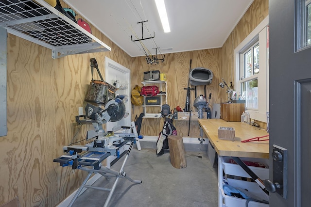 exercise room with a workshop area and wooden walls