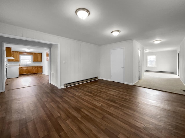 interior space featuring sink, baseboard heating, and dark wood-type flooring