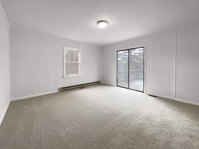 carpeted spare room featuring a baseboard radiator and wooden walls