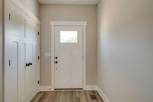 doorway with light wood-type flooring