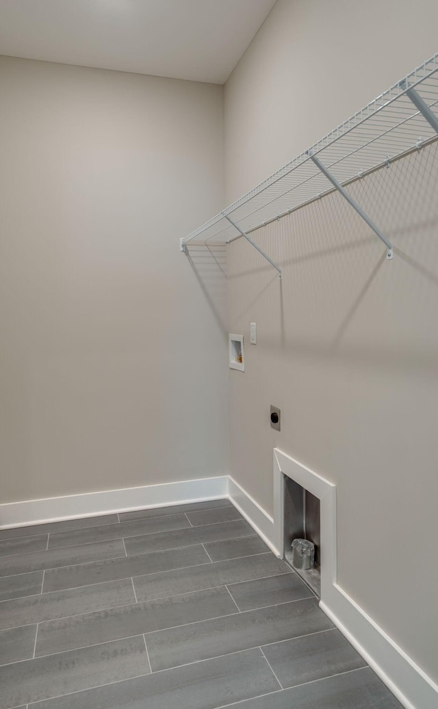 laundry room with hookup for an electric dryer, hookup for a washing machine, dark hardwood / wood-style floors, and a fireplace