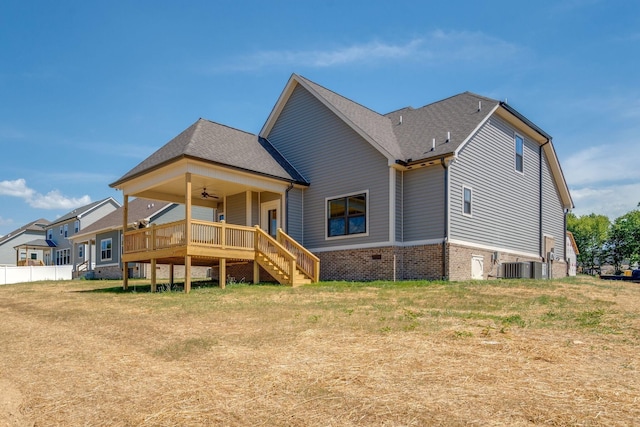 back of house with a lawn, ceiling fan, and central air condition unit