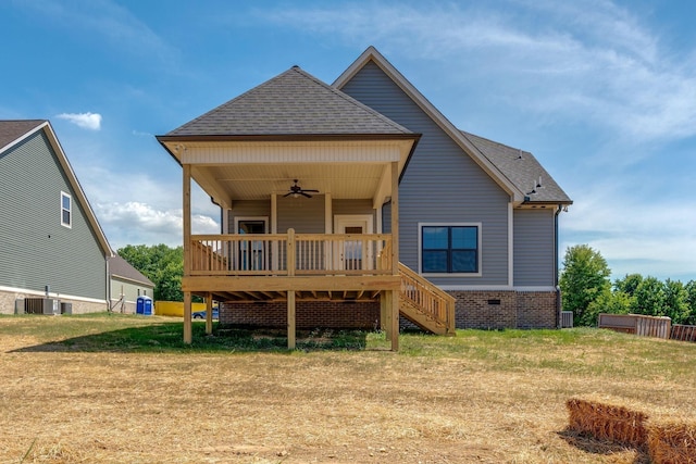 back of property featuring central AC unit, ceiling fan, a wooden deck, and a lawn