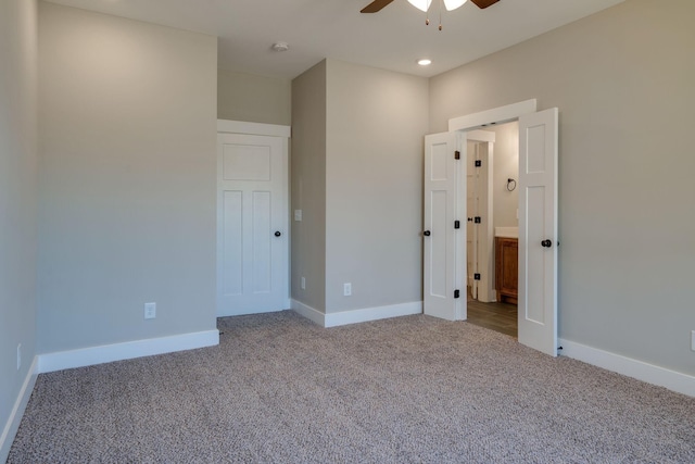 unfurnished bedroom with ceiling fan and light colored carpet