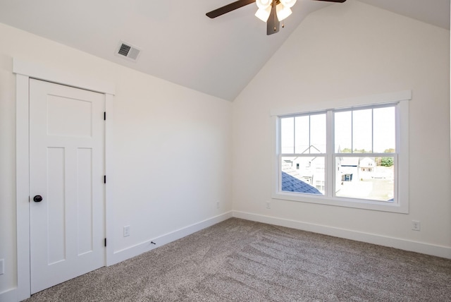 carpeted empty room with ceiling fan and high vaulted ceiling