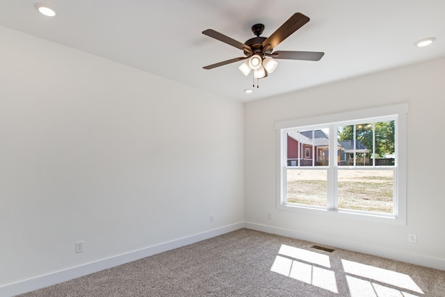 carpeted empty room featuring ceiling fan