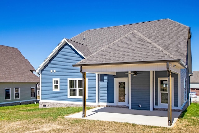 rear view of house featuring a lawn, ceiling fan, and a patio area