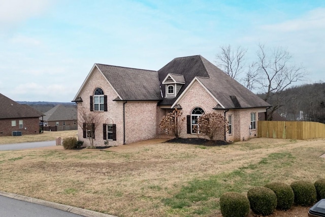 french provincial home with a front lawn