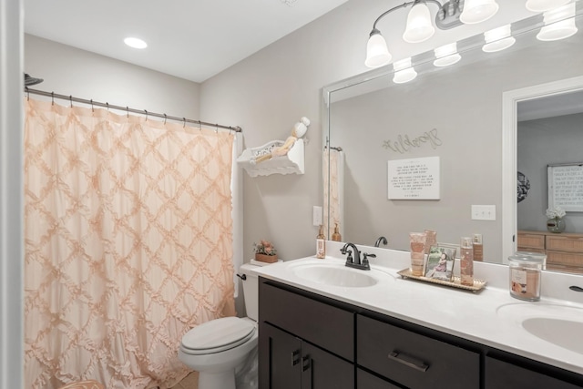 bathroom featuring vanity, a shower with shower curtain, and toilet