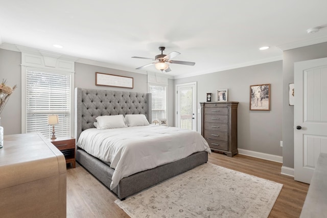 bedroom with multiple windows, ceiling fan, ornamental molding, and light wood-type flooring