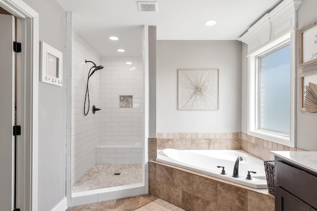 bathroom with vanity and independent shower and bath