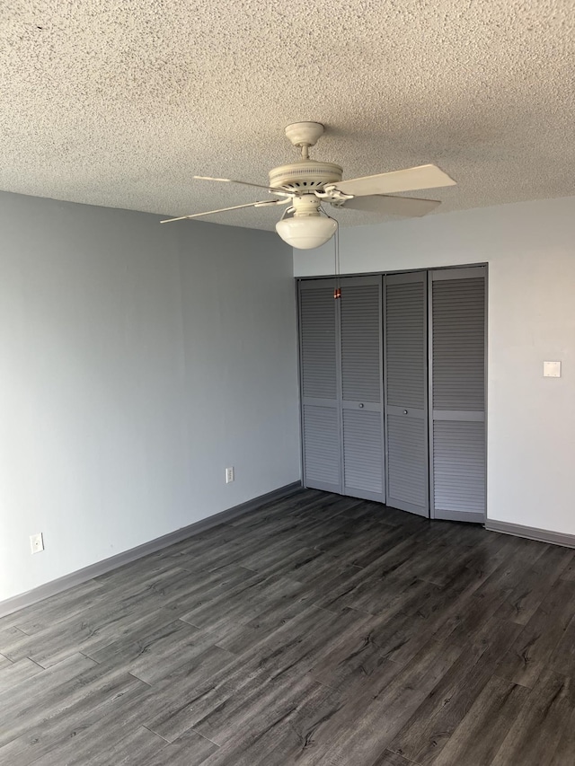 unfurnished bedroom with a closet, ceiling fan, dark hardwood / wood-style flooring, and a textured ceiling