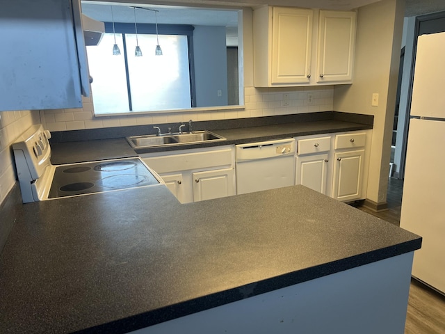 kitchen with decorative backsplash, white appliances, sink, pendant lighting, and white cabinets