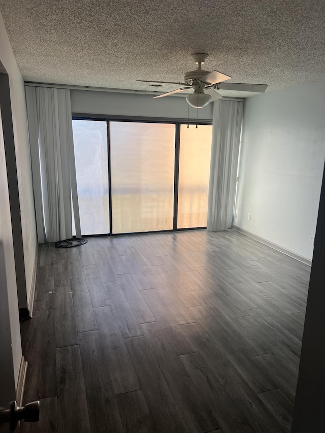 spare room with ceiling fan, dark hardwood / wood-style flooring, and a textured ceiling