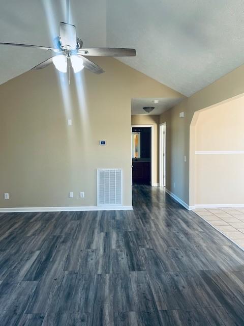 interior space featuring dark wood-type flooring and lofted ceiling