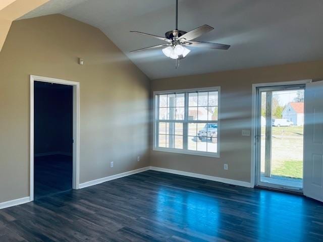 empty room with ceiling fan, lofted ceiling, and dark wood-type flooring