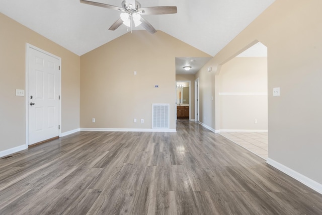 unfurnished living room featuring ceiling fan, lofted ceiling, and light hardwood / wood-style flooring